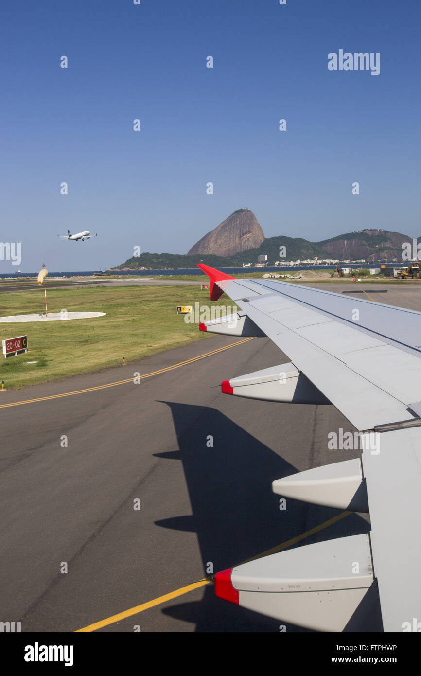 Detail of plane wing during landing at Santos Dumont Airport Stock Photo