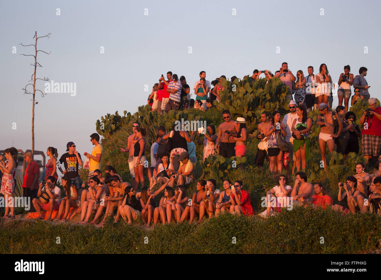 Tourists at the Arpoador rock watching the sunset Stock Photo