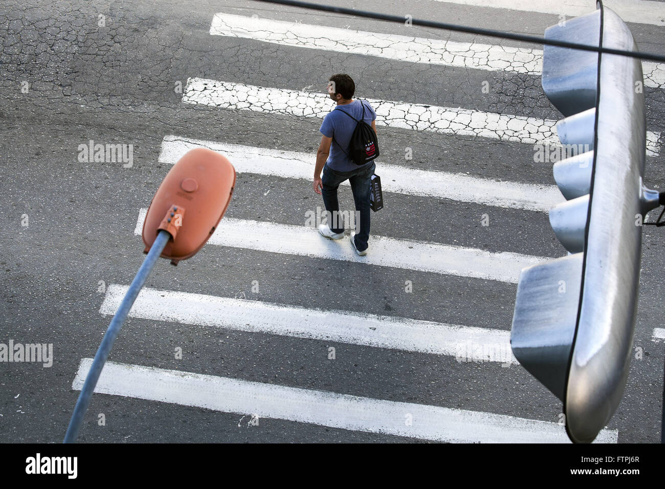 Man crossing crosswalk in the city center Stock Photo