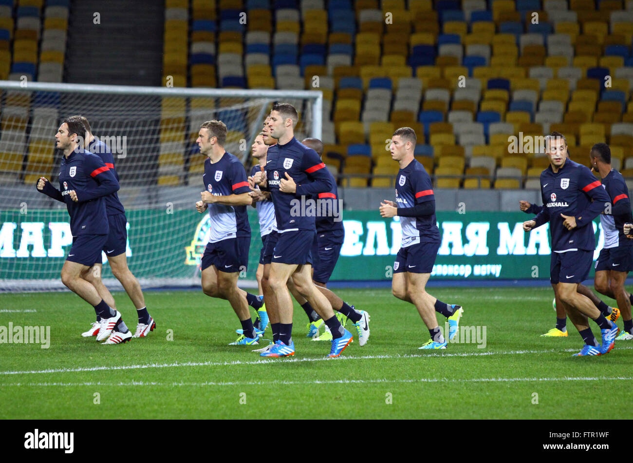 KYIV, UKRAINE - SEPTEMBER 9, 2013: England National football team players run during training session at NSC Olympic stadium before FIFA World Cup 2014 qualifier game against Ukraine Stock Photo