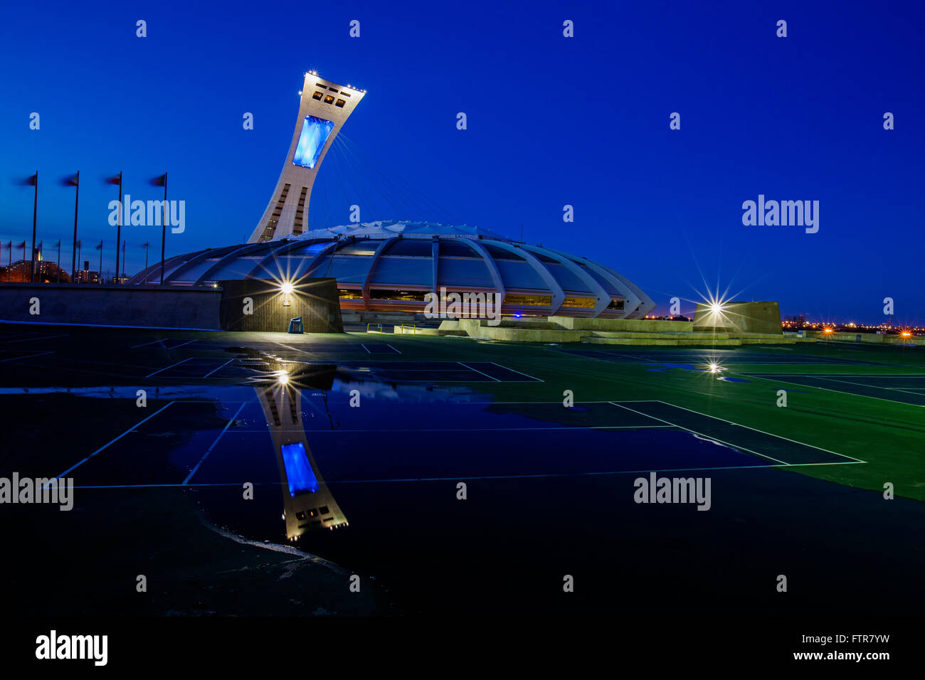 Blue hour at Olympic Stadium city Montreal Canada reflected in a water