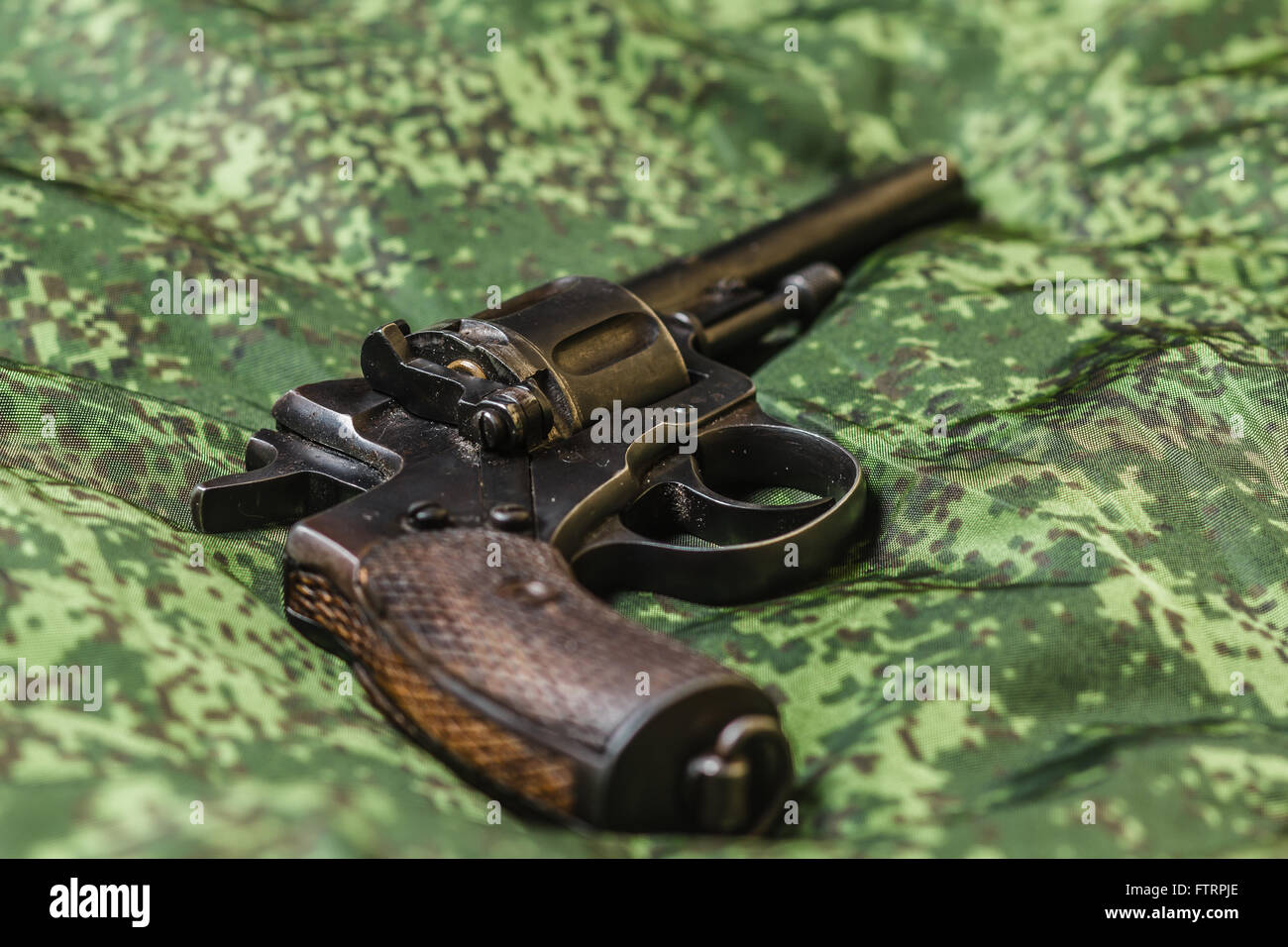 vintage pistol on pixel camouflage background Stock Photo