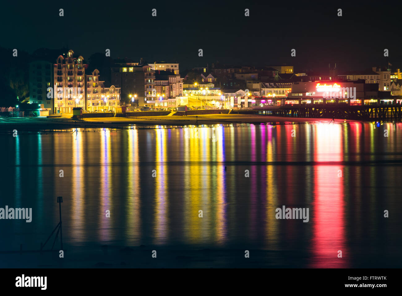 The view of Sandown Seafront and pier on the Isle of Wight, UK, as seen from Shanklin on a clear still night. Stock Photo
