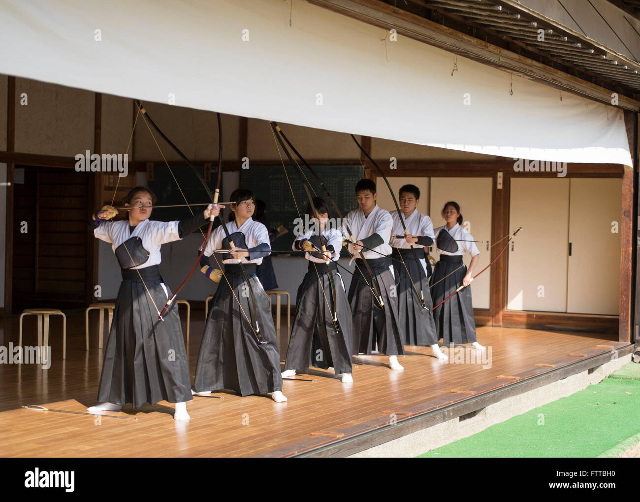 Young students practice kyudo Japanese archery at Kibitsu Shrine