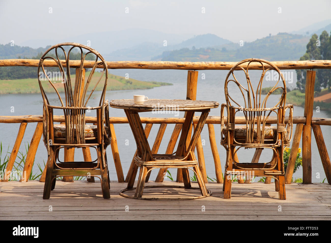 A relaxing looking set of wicker deck chairs beside a wicker table with ...
