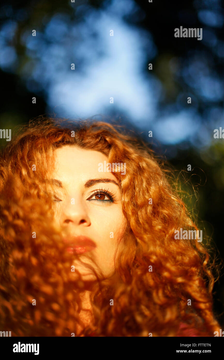 Curly woman closeup in golden hour Stock Photo