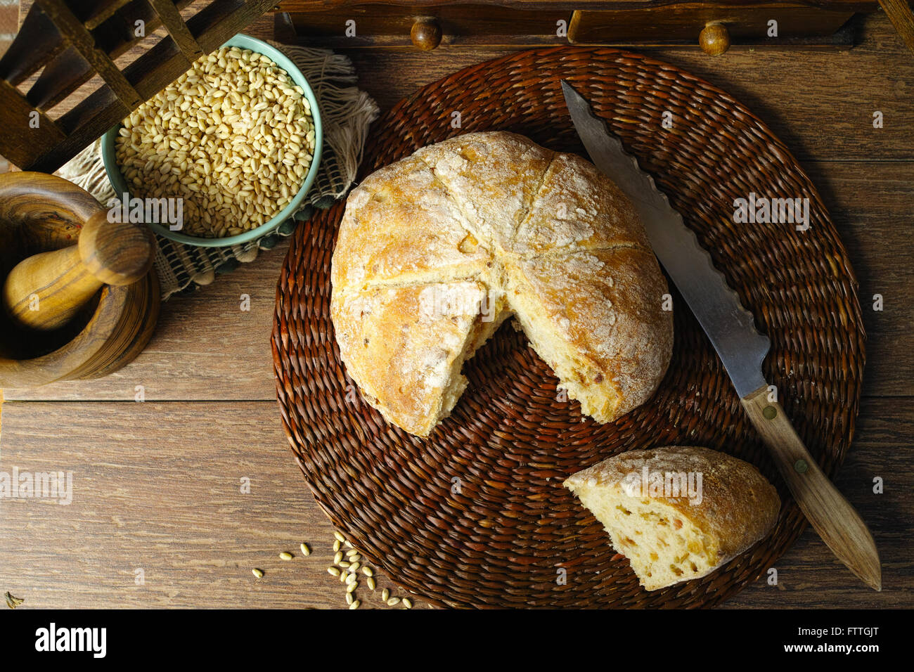 Round Loaf of Home made Bread with onion, whole wheat, in rural style on brick wall background Stock Photo
