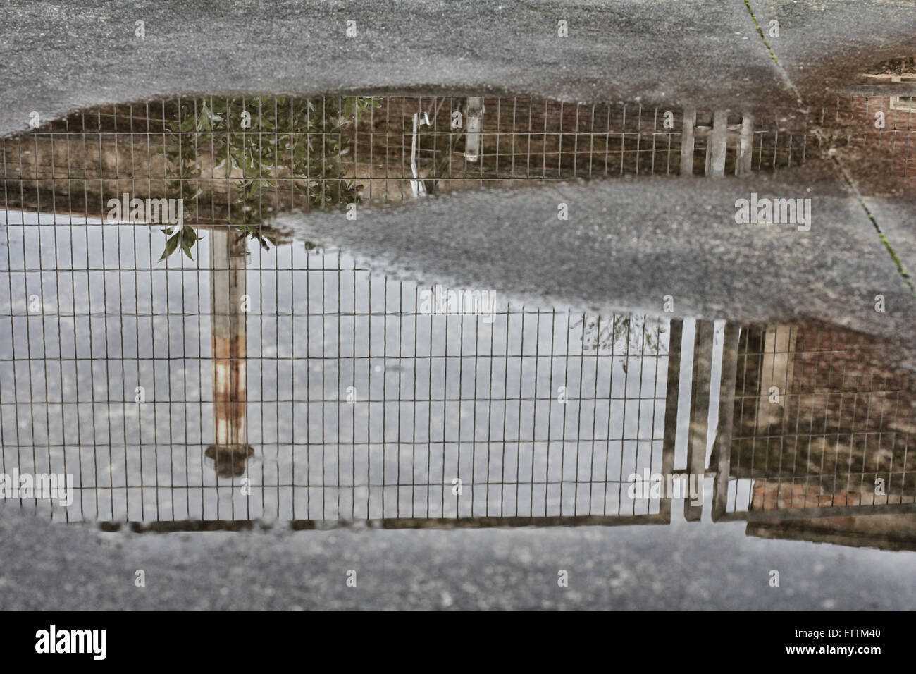 Factory is reflected on a puddle Stock Photo