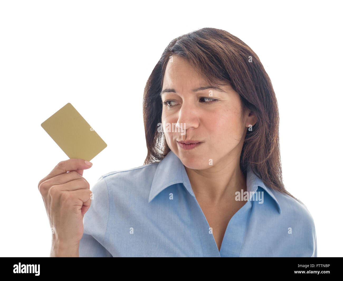 Photograph of a young mixed race woman looking warily at her credit card or gift card. Stock Photo