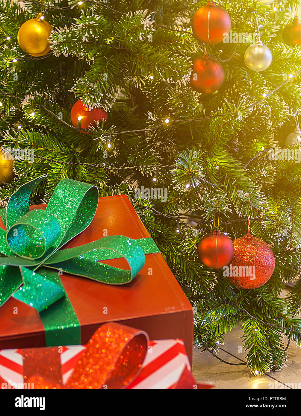 Red Christmas gift box with ribbon and ornaments of chrisrmas tree ...
