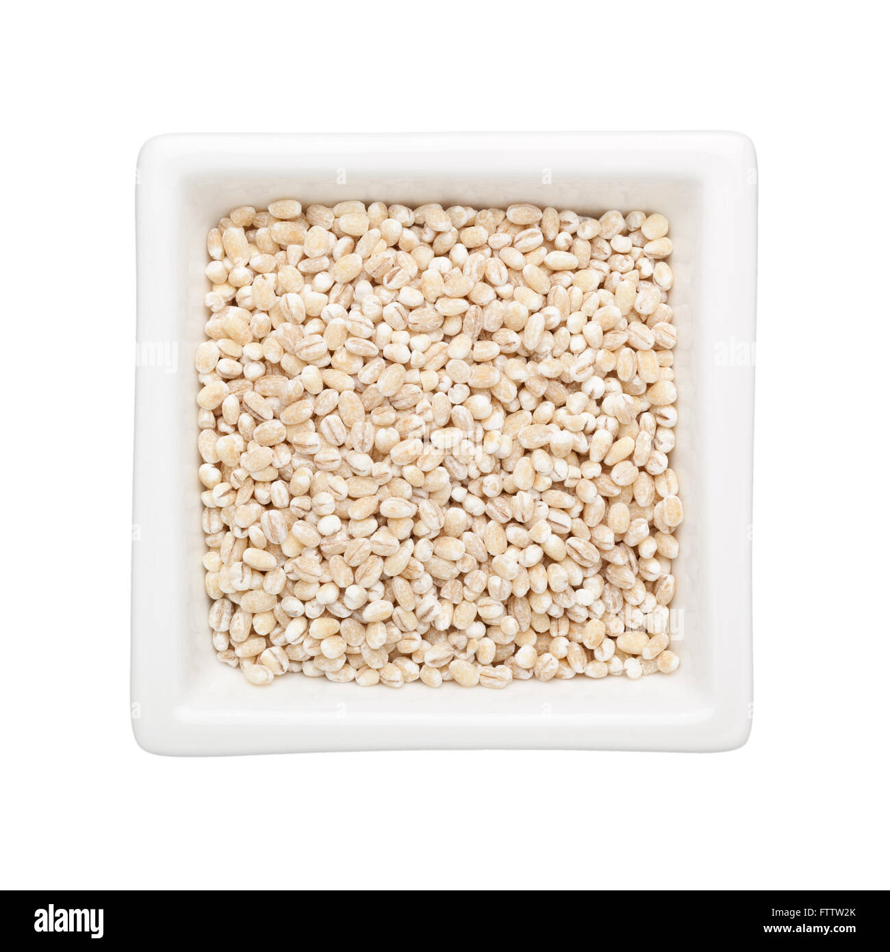 Barley grains in a square bowl isolated on white background Stock Photo