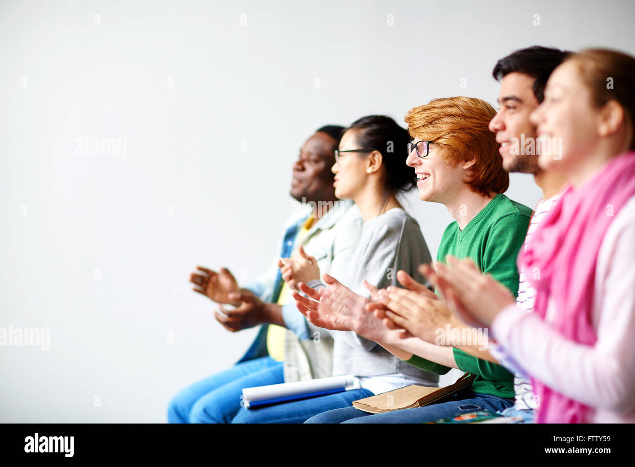 Students clapping hands Stock Photo
