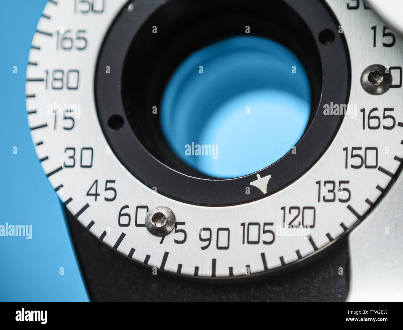 Photograph of a dial on a phoropter in an eye doctor's office. The dial is seen in close up with shallow depth of focus. Stock Photo