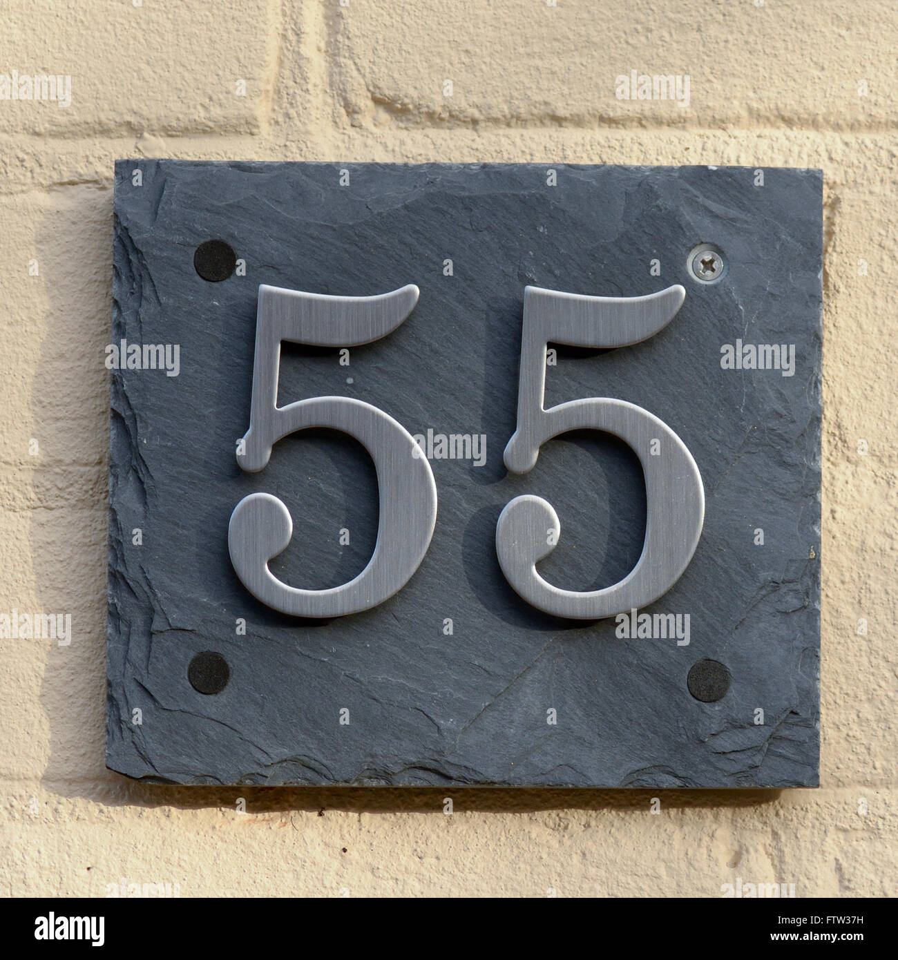 House number 55 sign on wall Stock Photo - Alamy