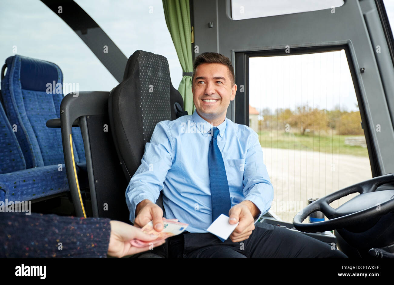 bus driver with money selling ticket to passenger Stock Photo Alamy