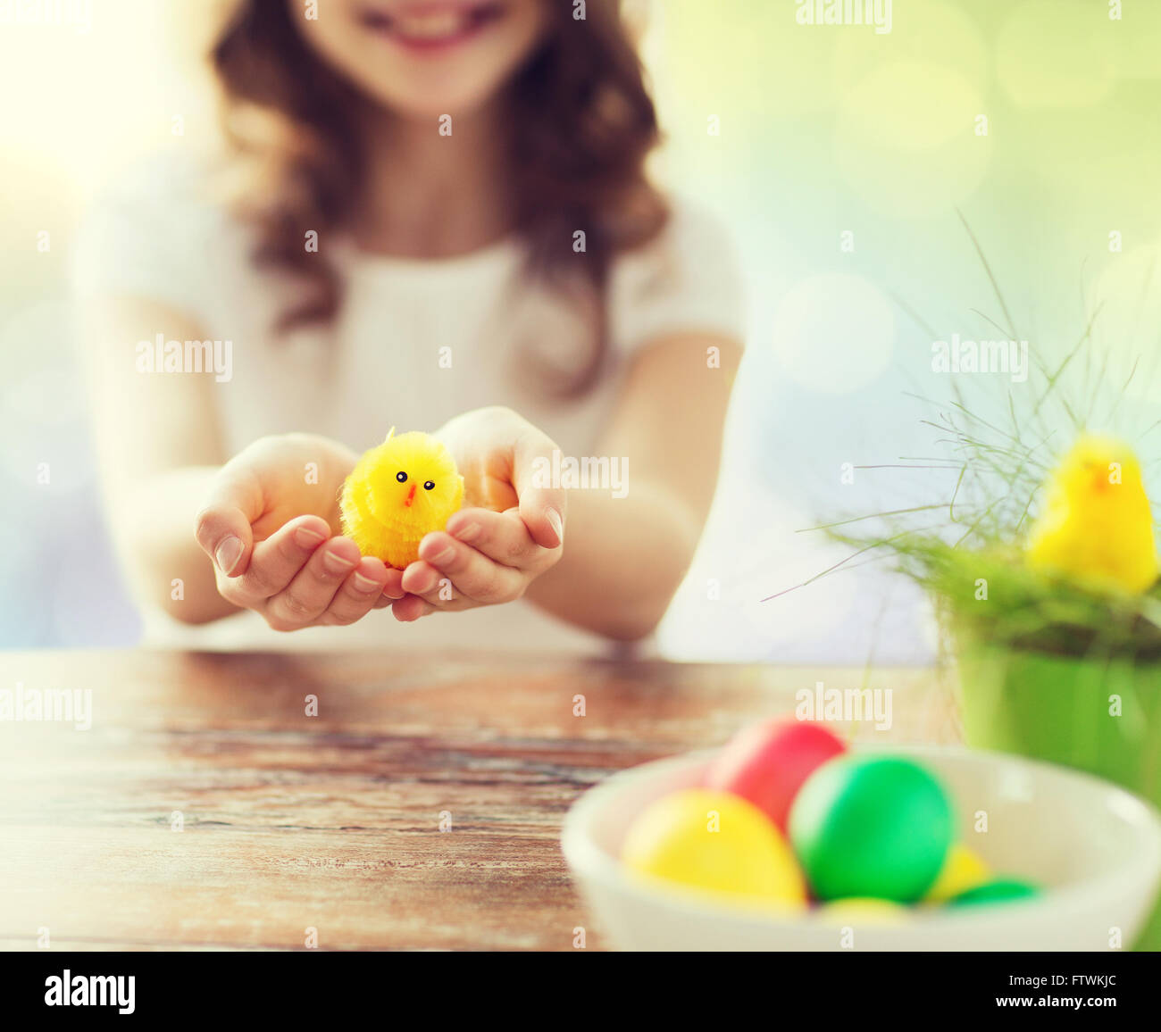 close up of girl holding easter chicken toy Stock Photo