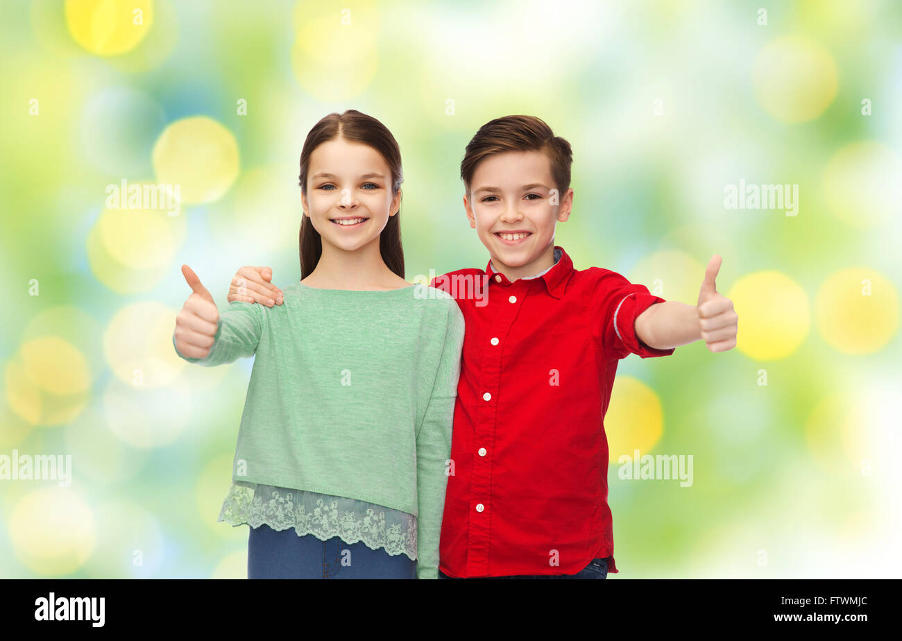 happy boy and girl showing thumbs up Stock Photo - Alamy