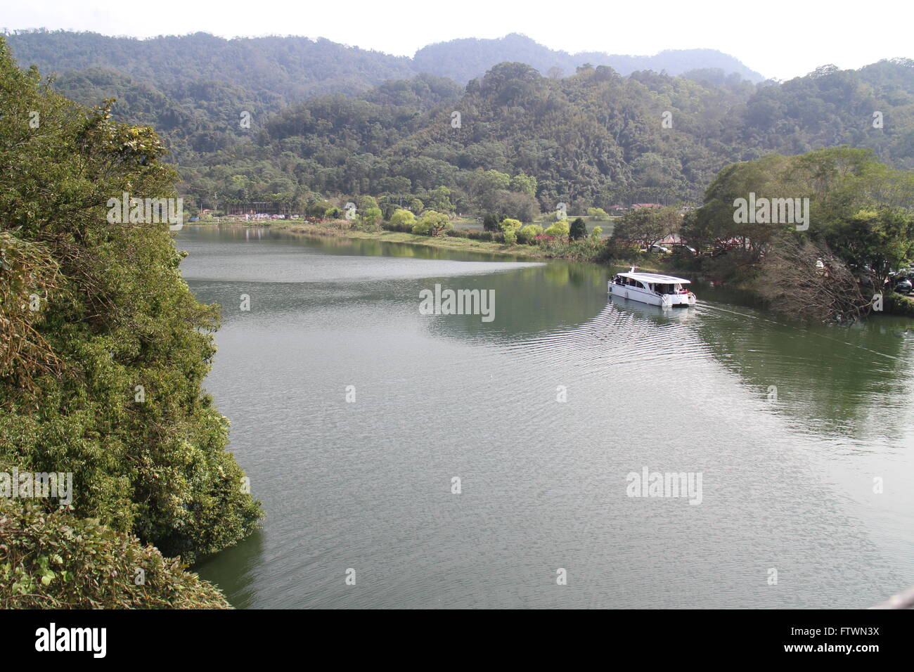A boat crossing the lake Stock Photo Alamy