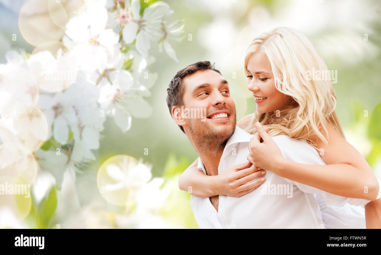 happy couple over cherry blossoms background Stock Photo - Alamy