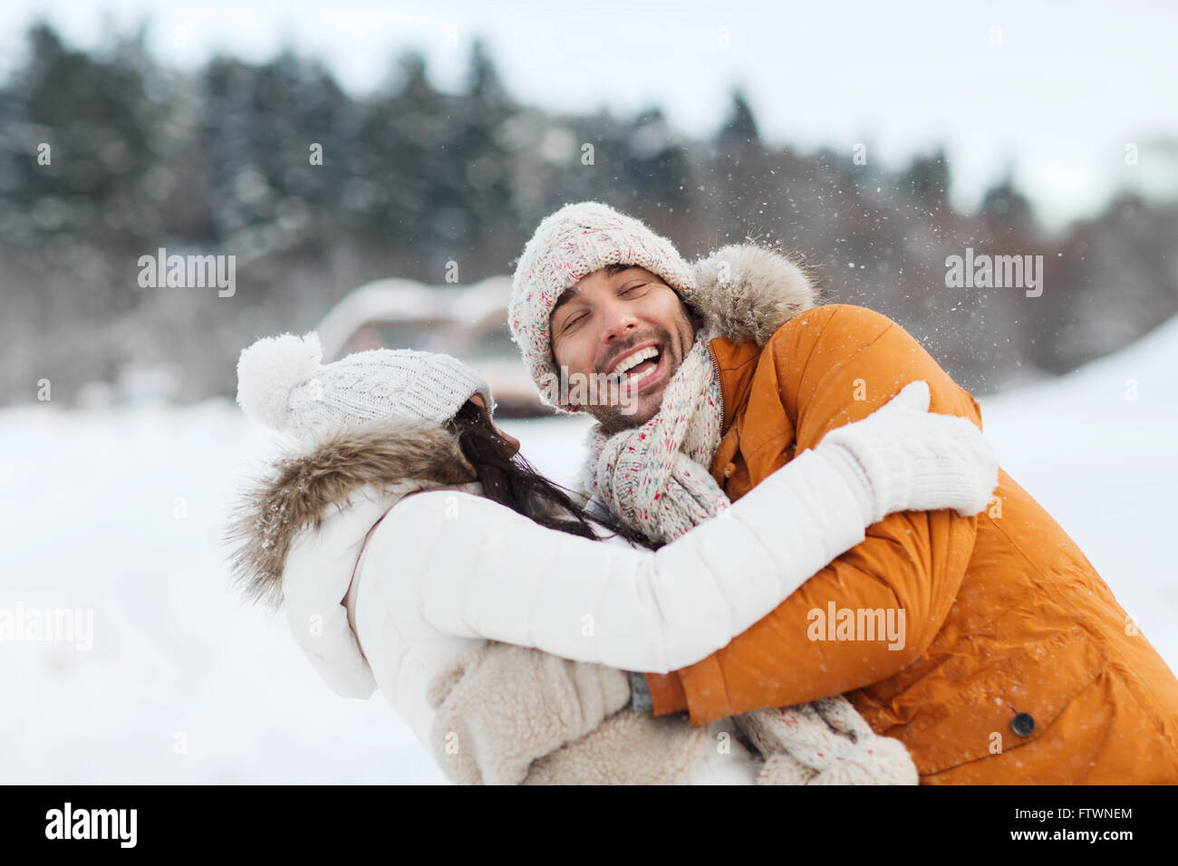 happy couple hugging and laughing in winter Stock Photo - Alamy