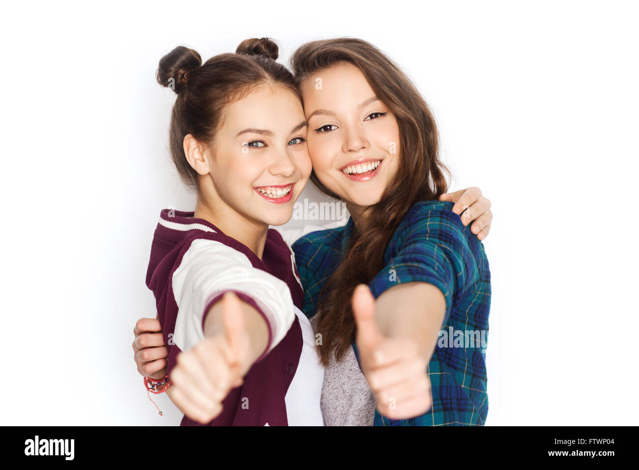 happy smiling teenage girls showing thumbs up Stock Photo - Alamy