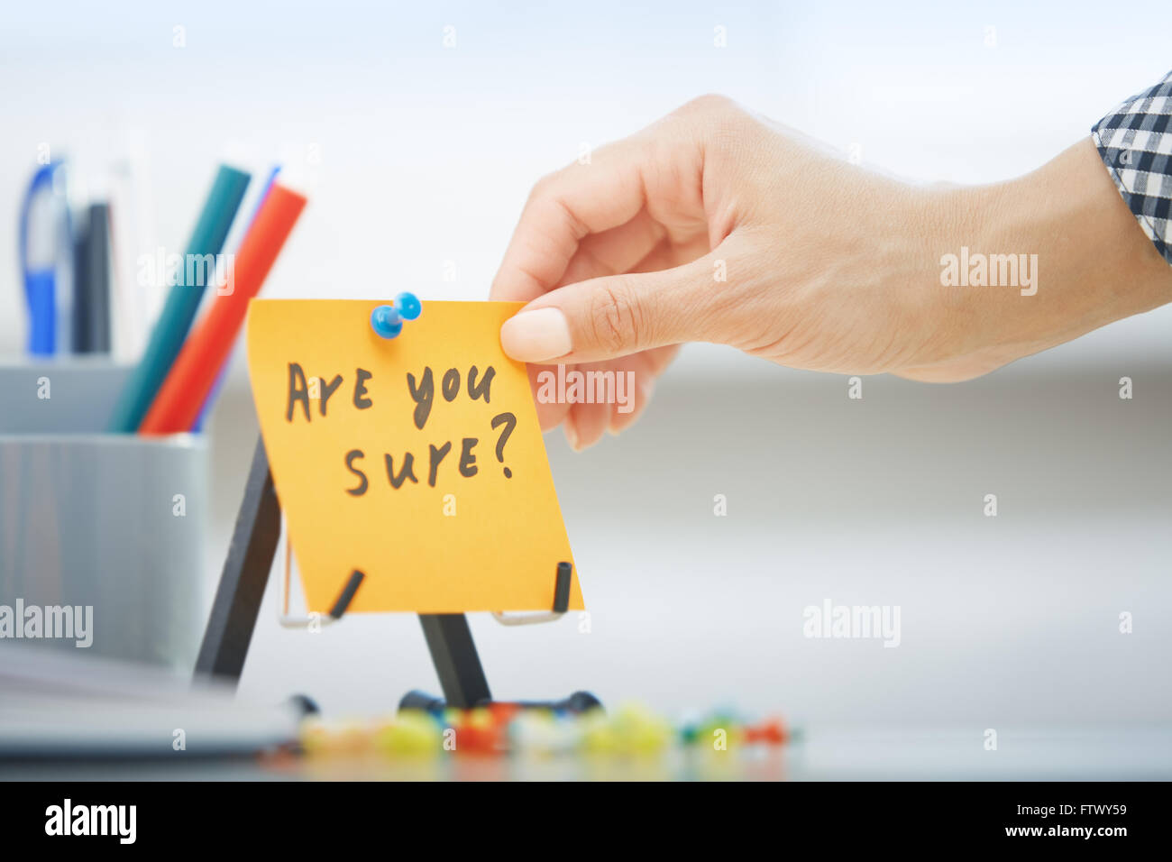 Human hand holding adhesive note with Are you sure text Stock Photo - Alamy