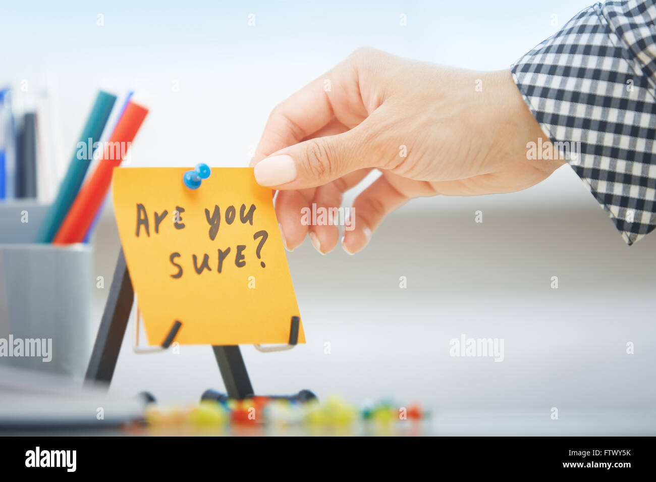 Human hand holding adhesive note with Are you sure text Stock Photo - Alamy