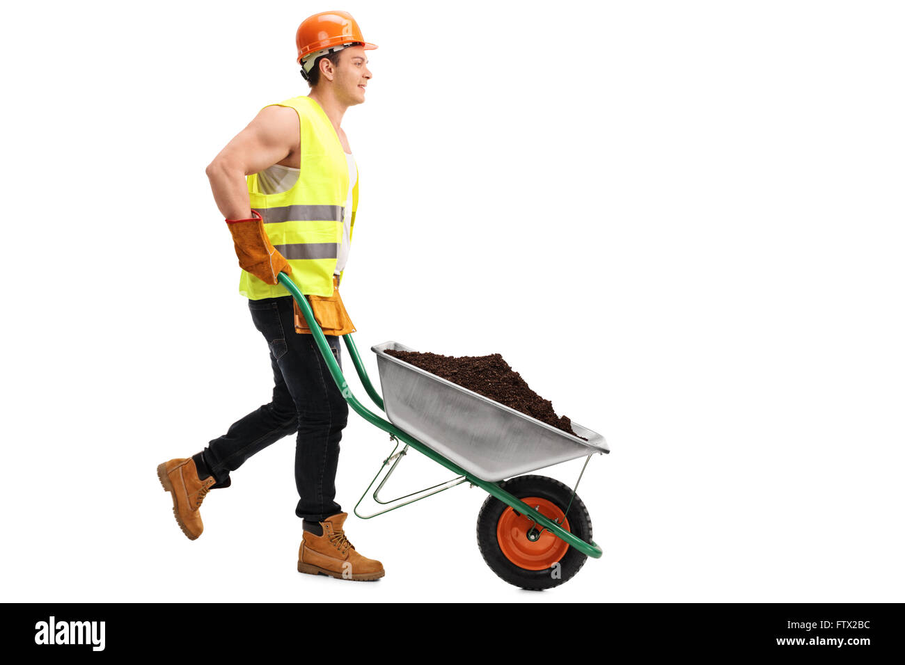 Construction worker pushing a wheelbarrow with a pile of dirt in it