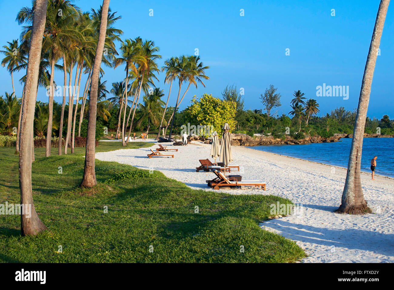 White sandy beach below palm trees in front of The Residence Hotel at the Indian Ocean Zanzibar Tanzania Stock Photo