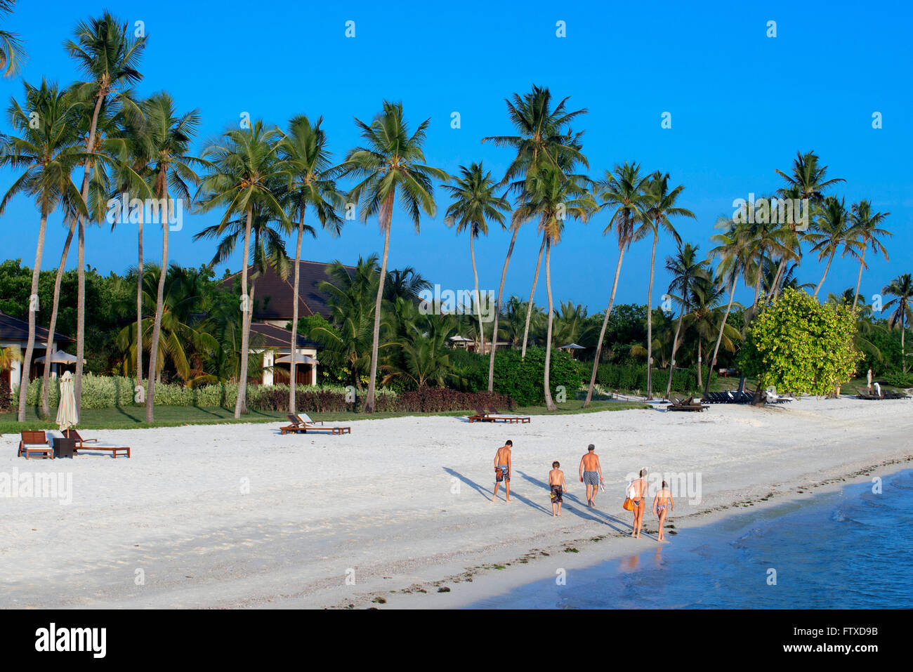 White sandy beach below palm trees in front of The Residence Hotel at the Indian Ocean Zanzibar Tanzania Stock Photo