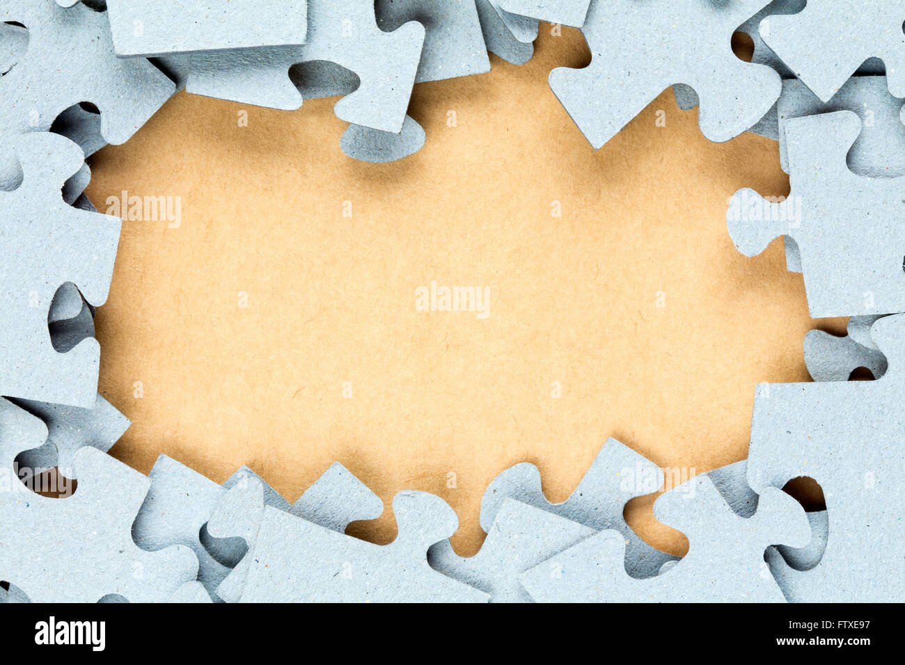 Blue jigsaw frame with paper background for copy-space Stock Photo