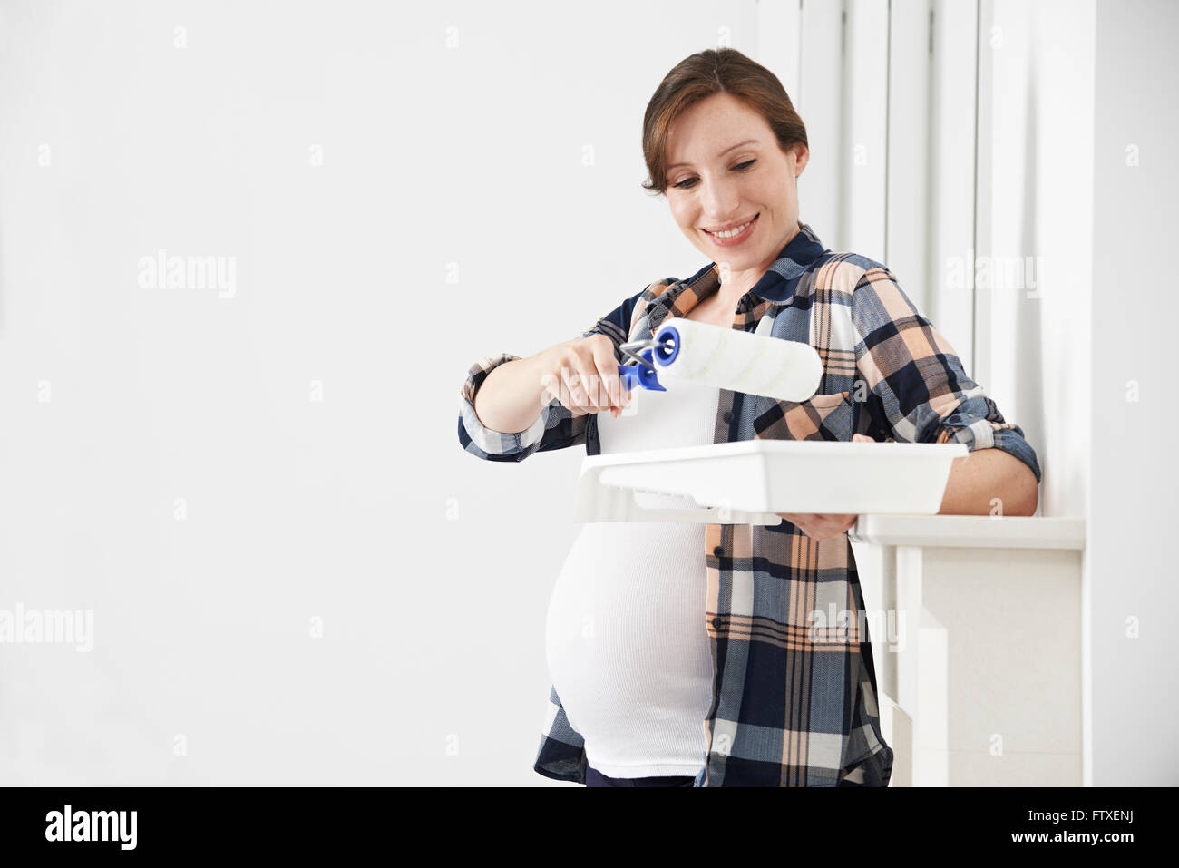 Portrait Of Pregnant Woman Decorating Nursery Stock Photo Alamy