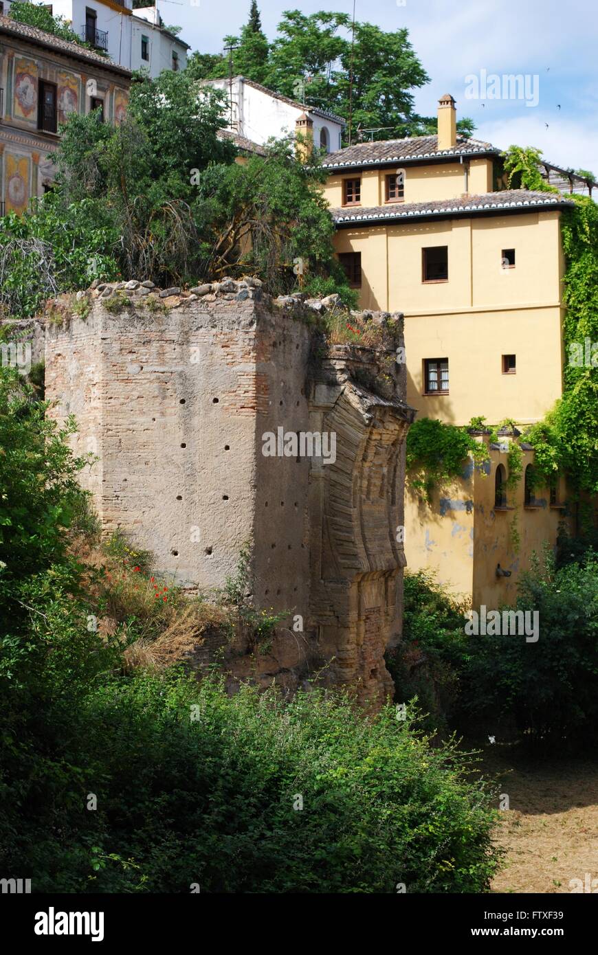 Ruins of a Moorish arch across the River Darro along the Carrera del Darro in the Albaicin, Granada, Granada Province, Spain. Stock Photo