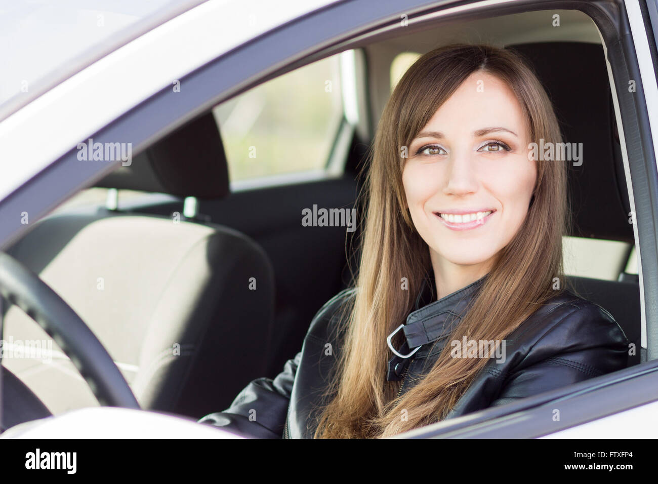 Young confident car driver woman steering wheel. Happy caucasian girl  in her own car Stock Photo