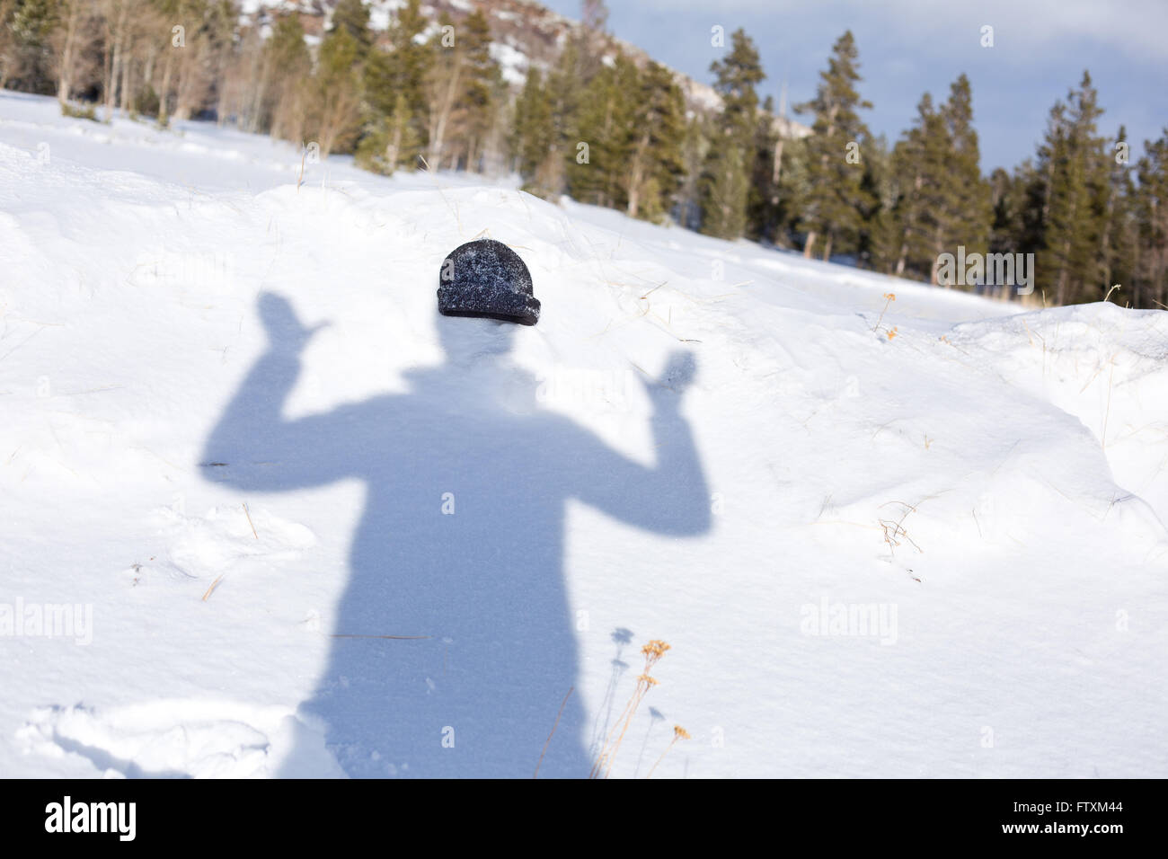 Shadow of a woman with a hat in snow, Wyoming, america, USA Stock Photo