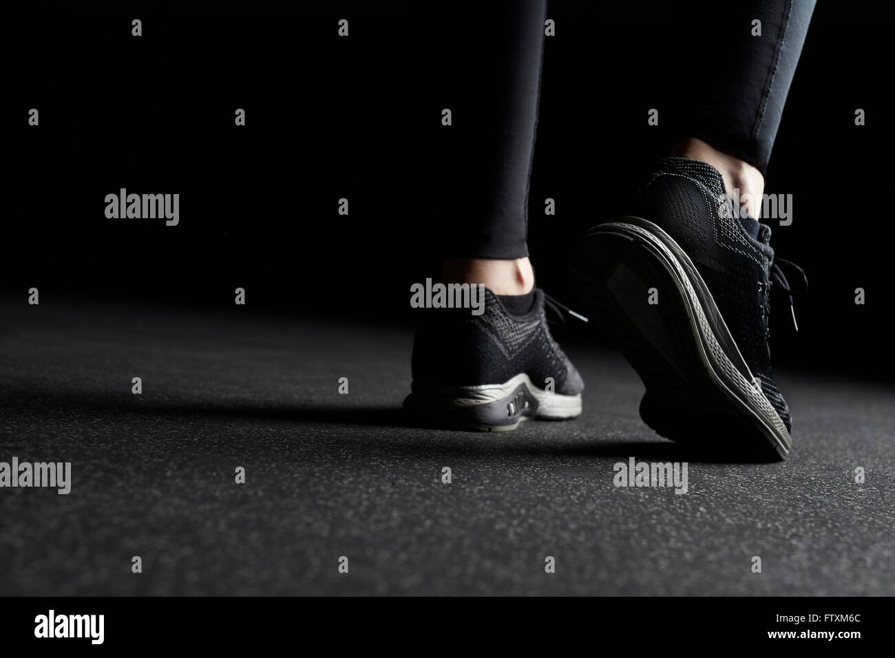 Close-up of Woman's legs in trainers at gym Stock Photo