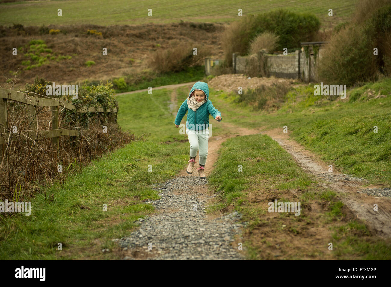 Girl running up a hill Stock Photo Alamy