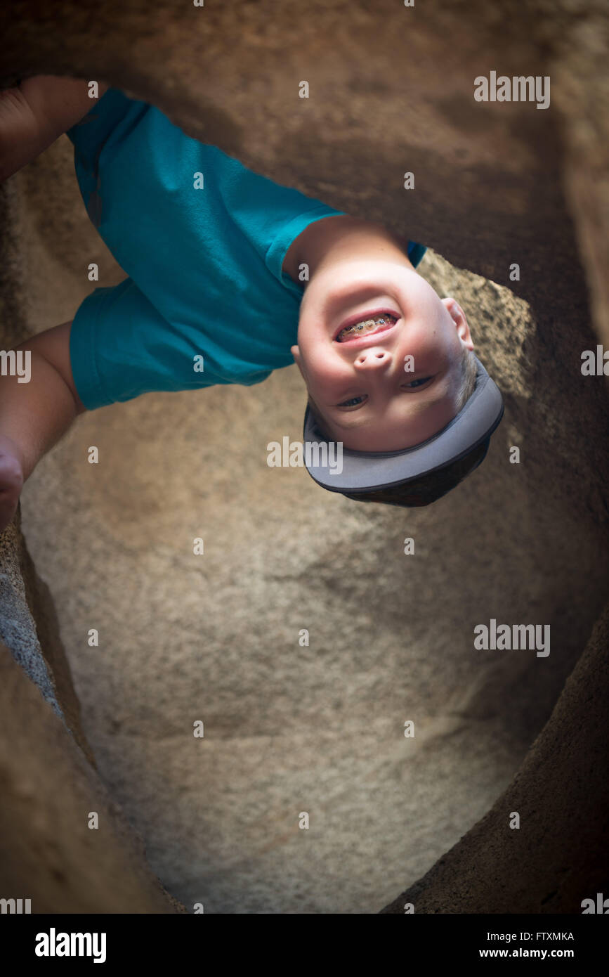 Boy exploring cave Stock Photo