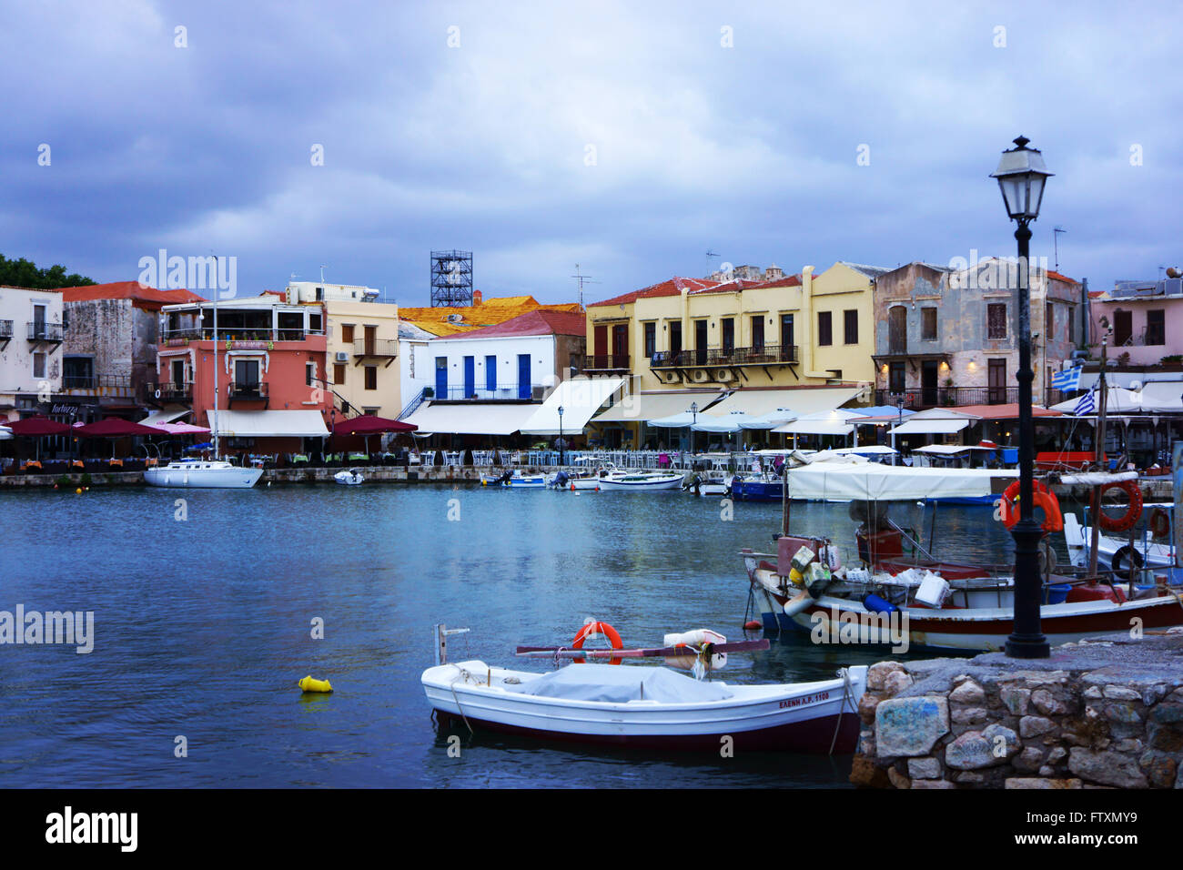 Harbor and restaurants along harbor in old town Rhetimno, island Crete, Greece Stock Photo
