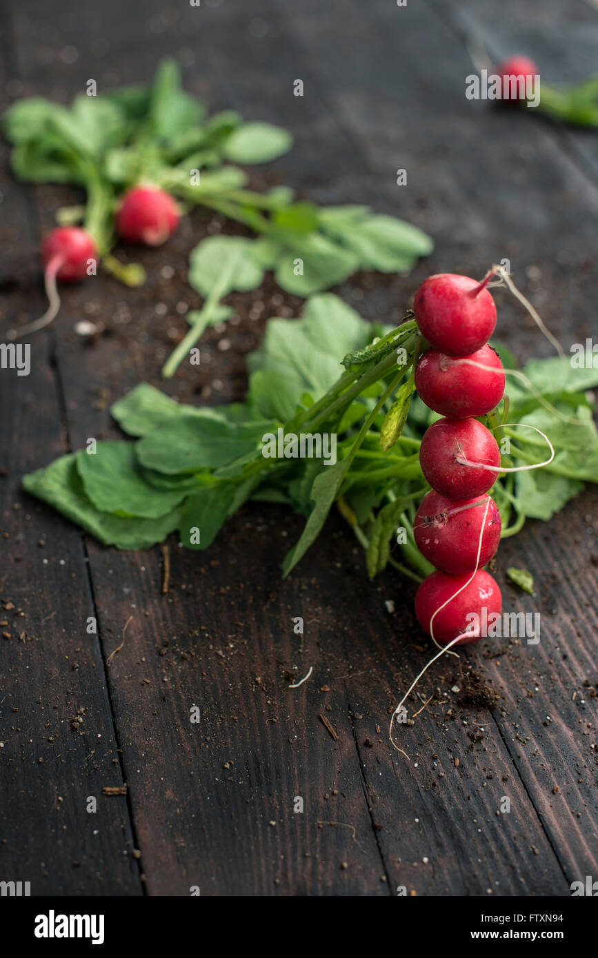 Stack of radishes on wooden table Stock Photo