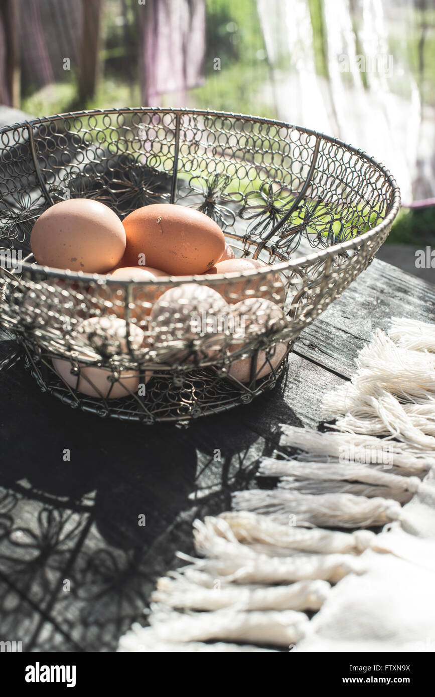 Eggs in a metal basket Stock Photo