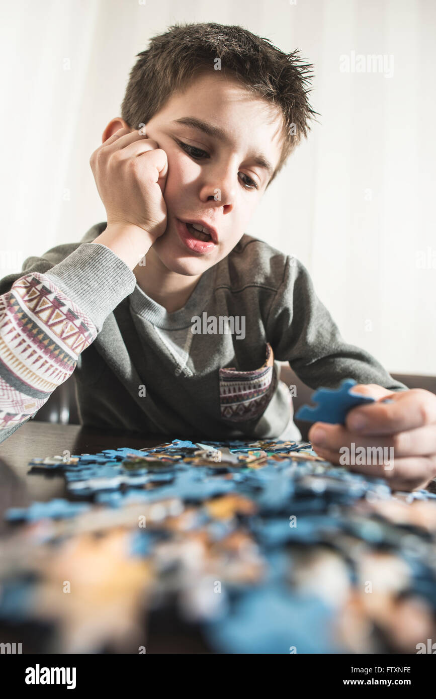 Boy assembling a jigsaw puzzle Stock Photo