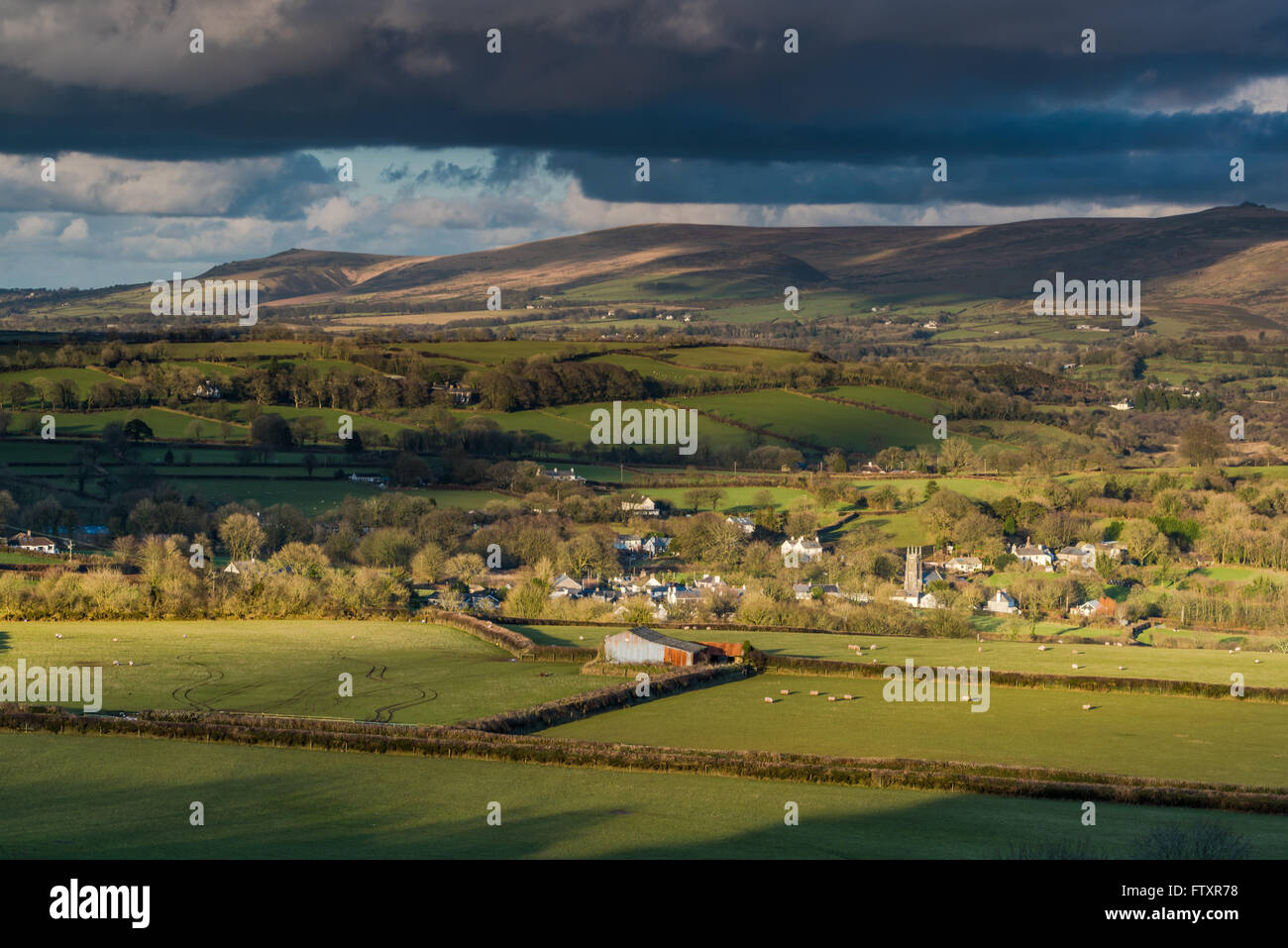 Panoramic landscape, rolling hills and cloudy sky. View from hill top,long shadows at sunset. Stock Photo