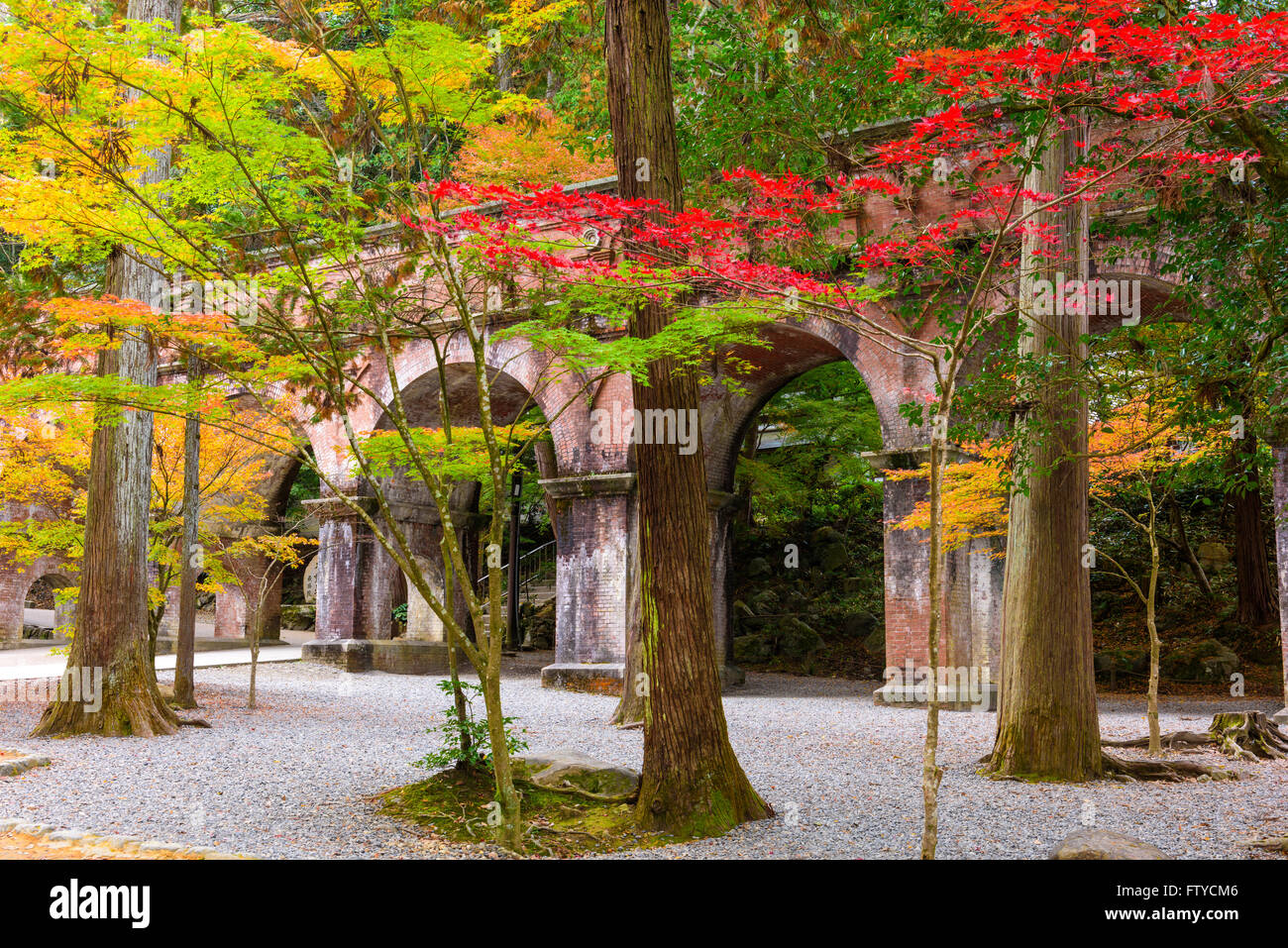 Kyoto, Japan at the Nanzenji Temple aqueduct behind autumn foliage. Stock Photo