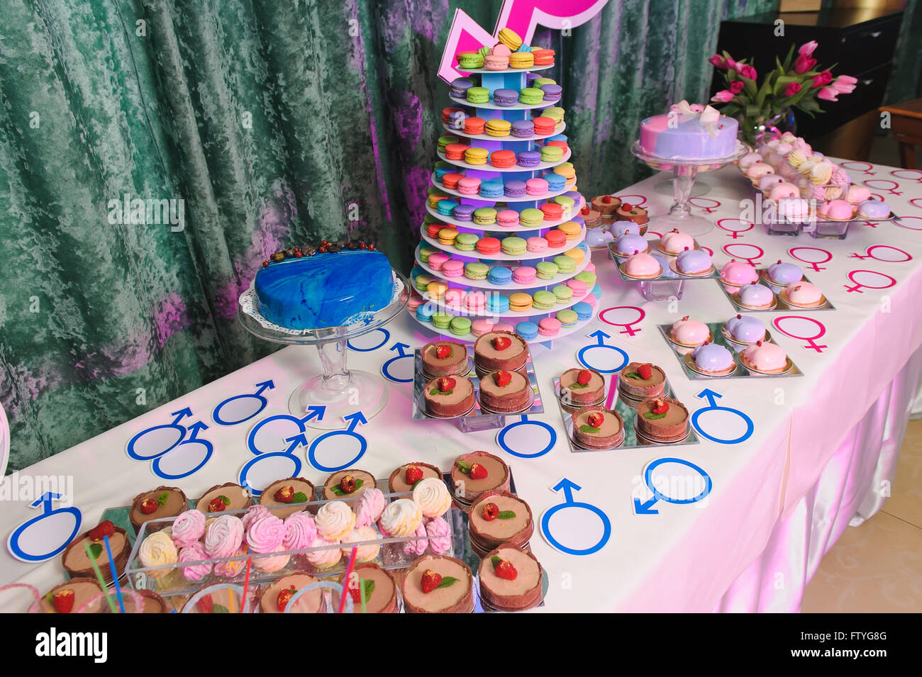 gender reveal party with macaroon tower and cakes Stock Photo - Alamy