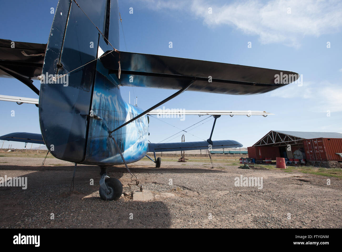 Kazakhstan, Kazakistan, Asia, landed agriculture airplane, biplane near to the hangar. Stock Photo