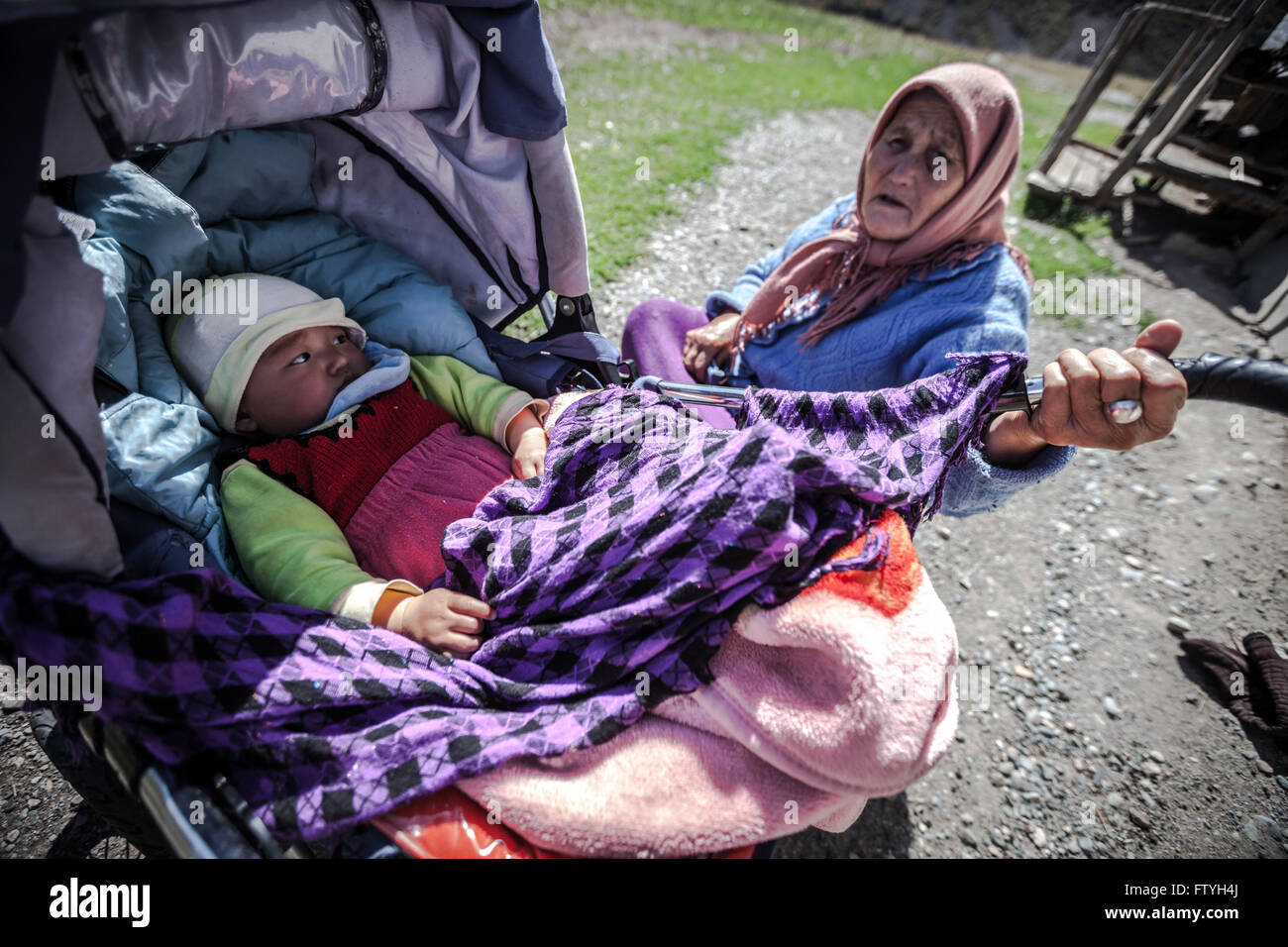 Kazakhstan, Kazakistan, a grandmother and baby in carriage. Stock Photo