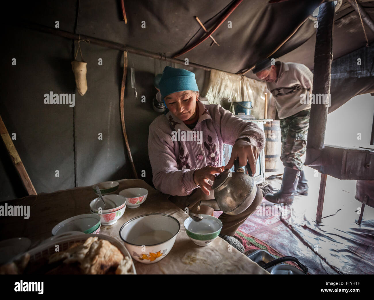 Kyrgyzstan, Kirghizistan, Asia,everyday family life in yurta, woman cooking Stock Photo