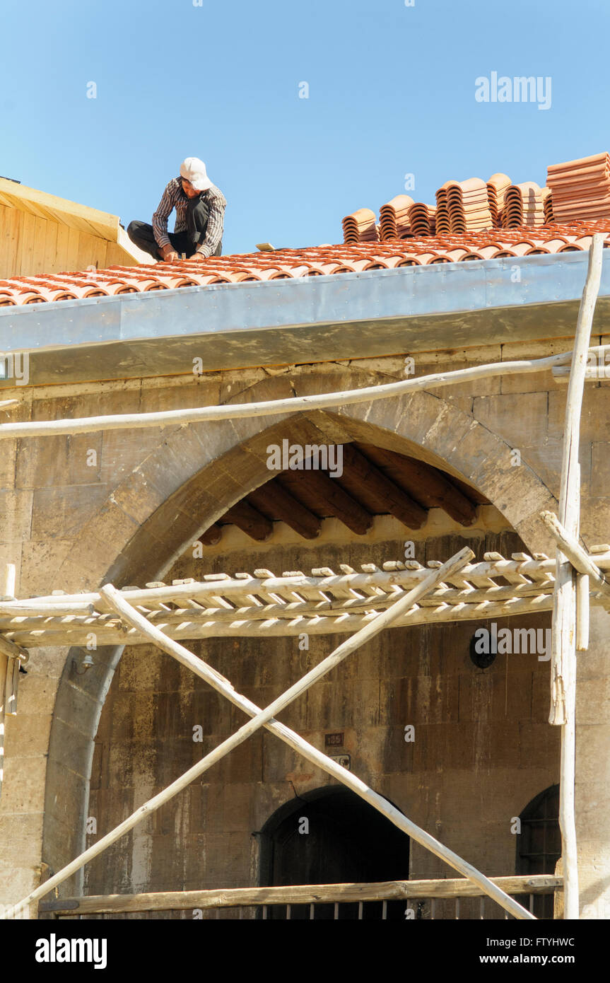 Man laying traditional terracotta roof tiles in Gaziantep, Turkey Stock Photo