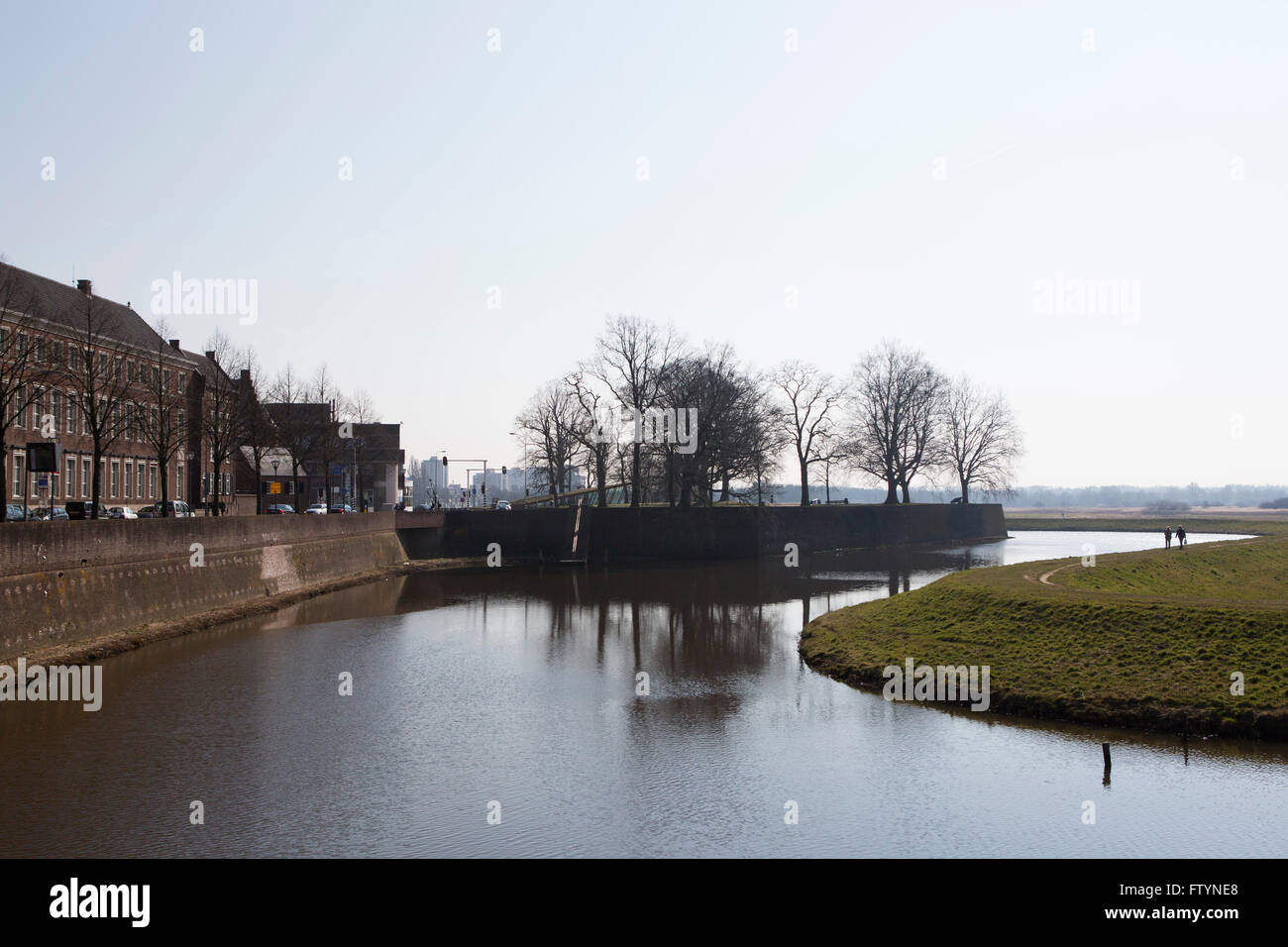 A moat protecting 's-Hertogenbosch in the Netherlands. The waterway flows around the city ramparts. Stock Photo